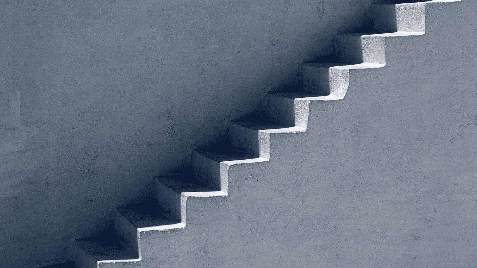 Plain plaster steps climbing diagonally along a bare wall